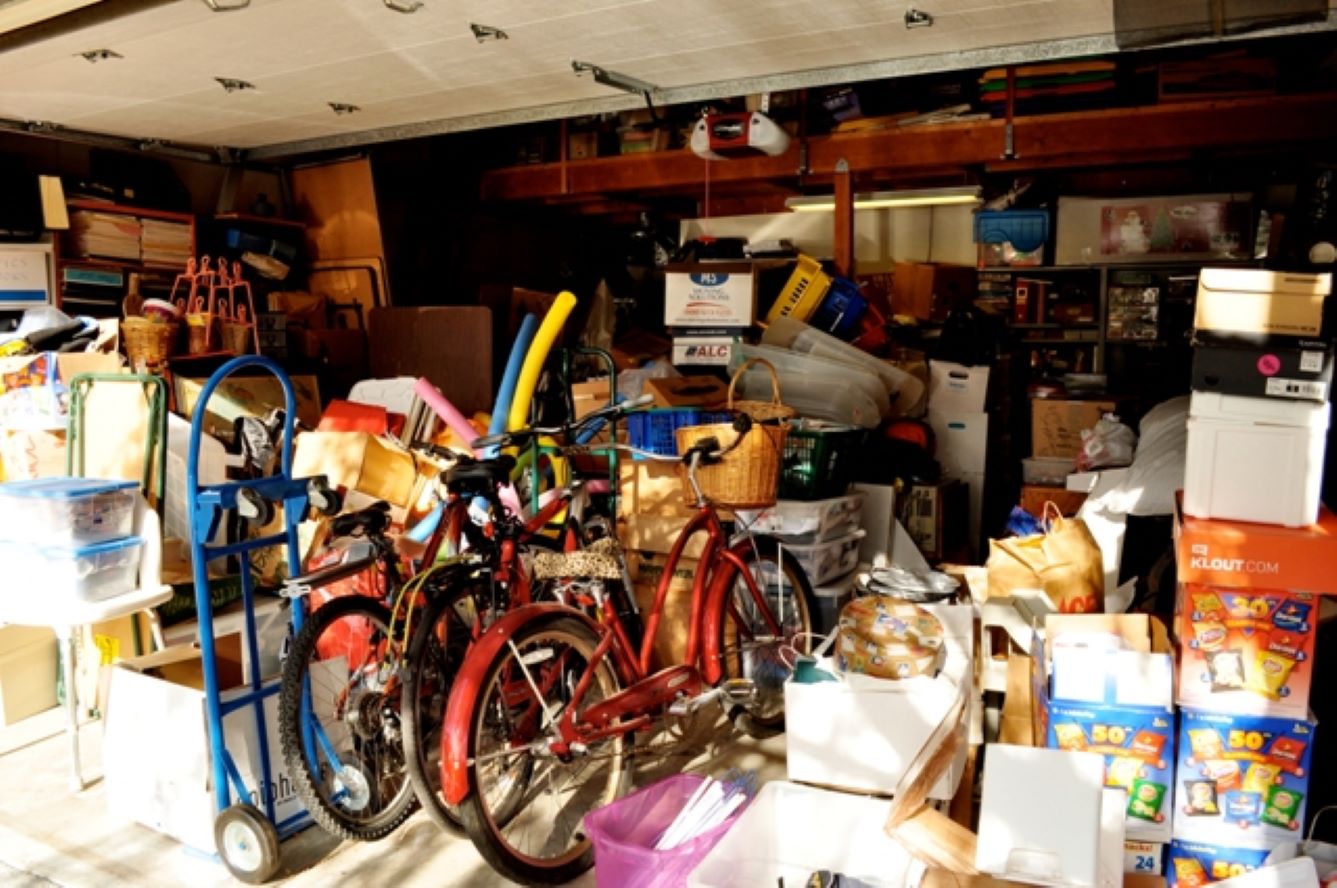 cluttered garage full of boxes and bikes